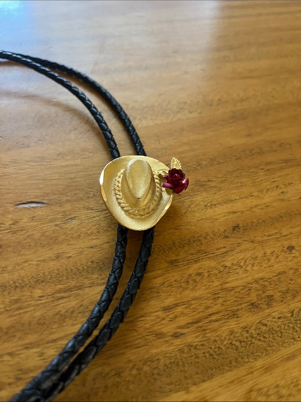 Black Braided Bolo Tie with Beige Cowboy Hat Slide and Red Rose Accent